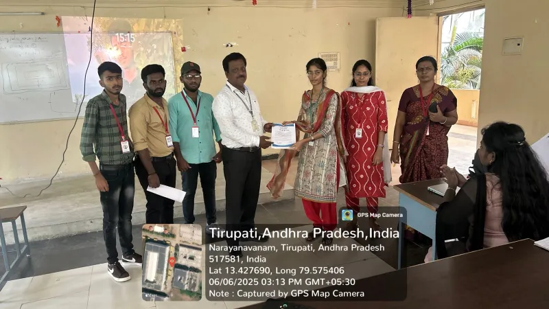 A certificate being presented with program participants in a classroom
